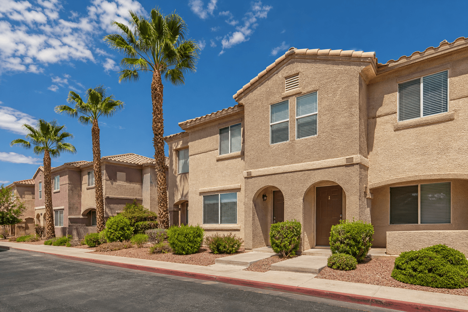 Affordable two-story townhomes in North Las Vegas under a clear desert sky